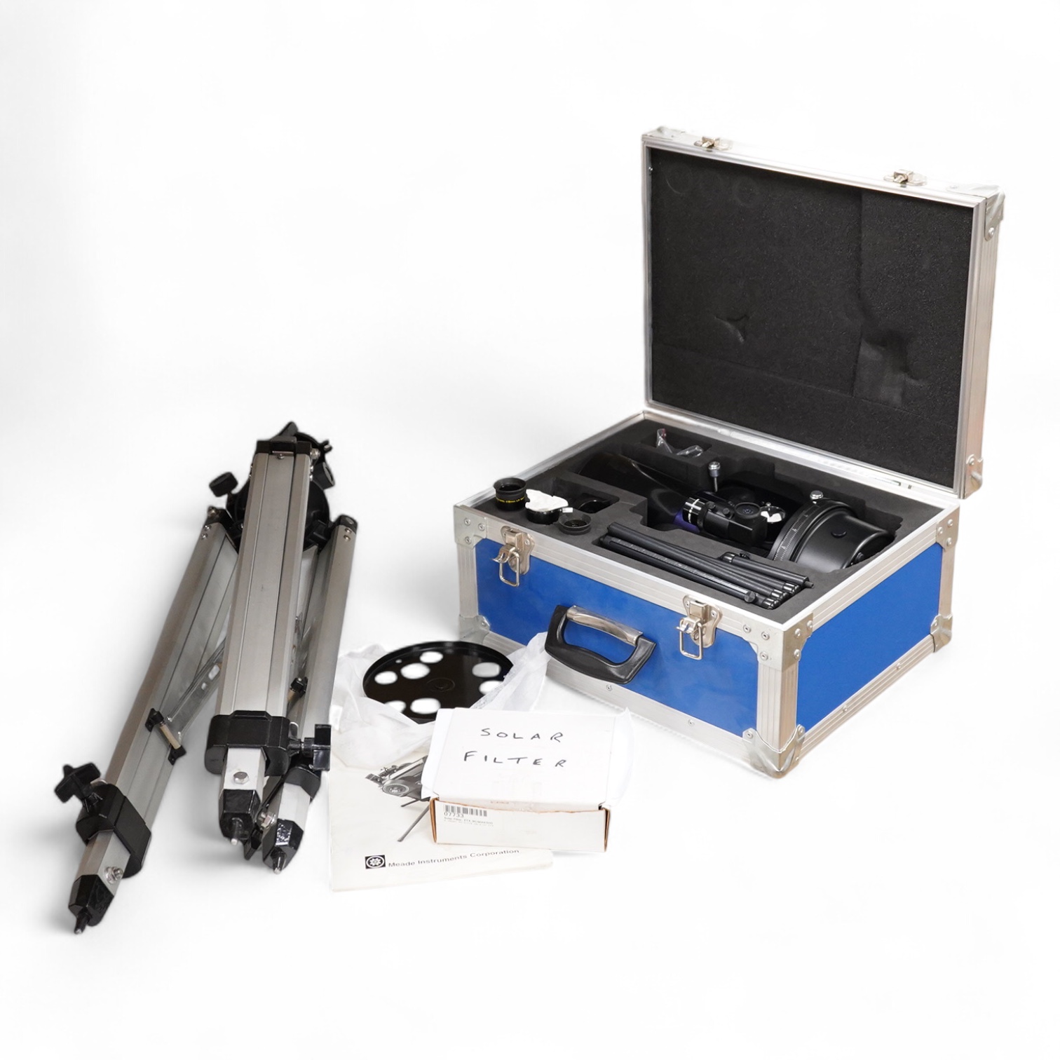 A cased Meade ETX Astro telescope, with instruction manual contained within the original flight case, 46 x 36 x 23cm, together with an additional Orion glass solar filter and tripod